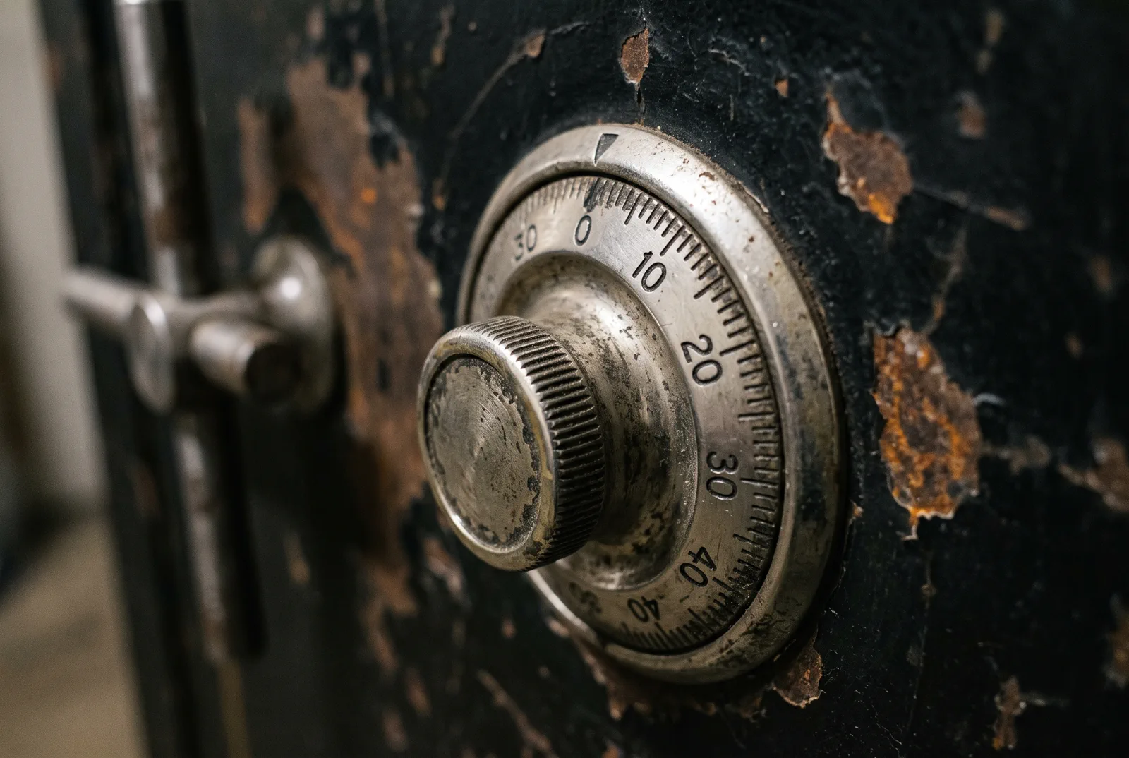 The dial of an older safe, worn around the numbers